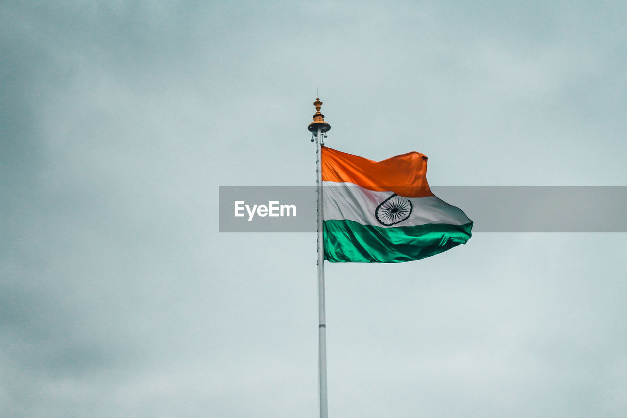 Low angle view of indian flag against sky