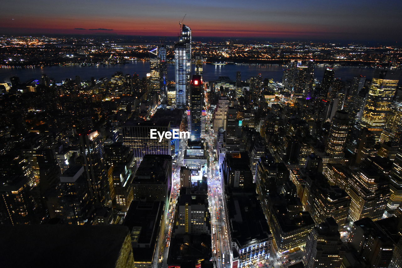 High angle view of illuminated city buildings at night