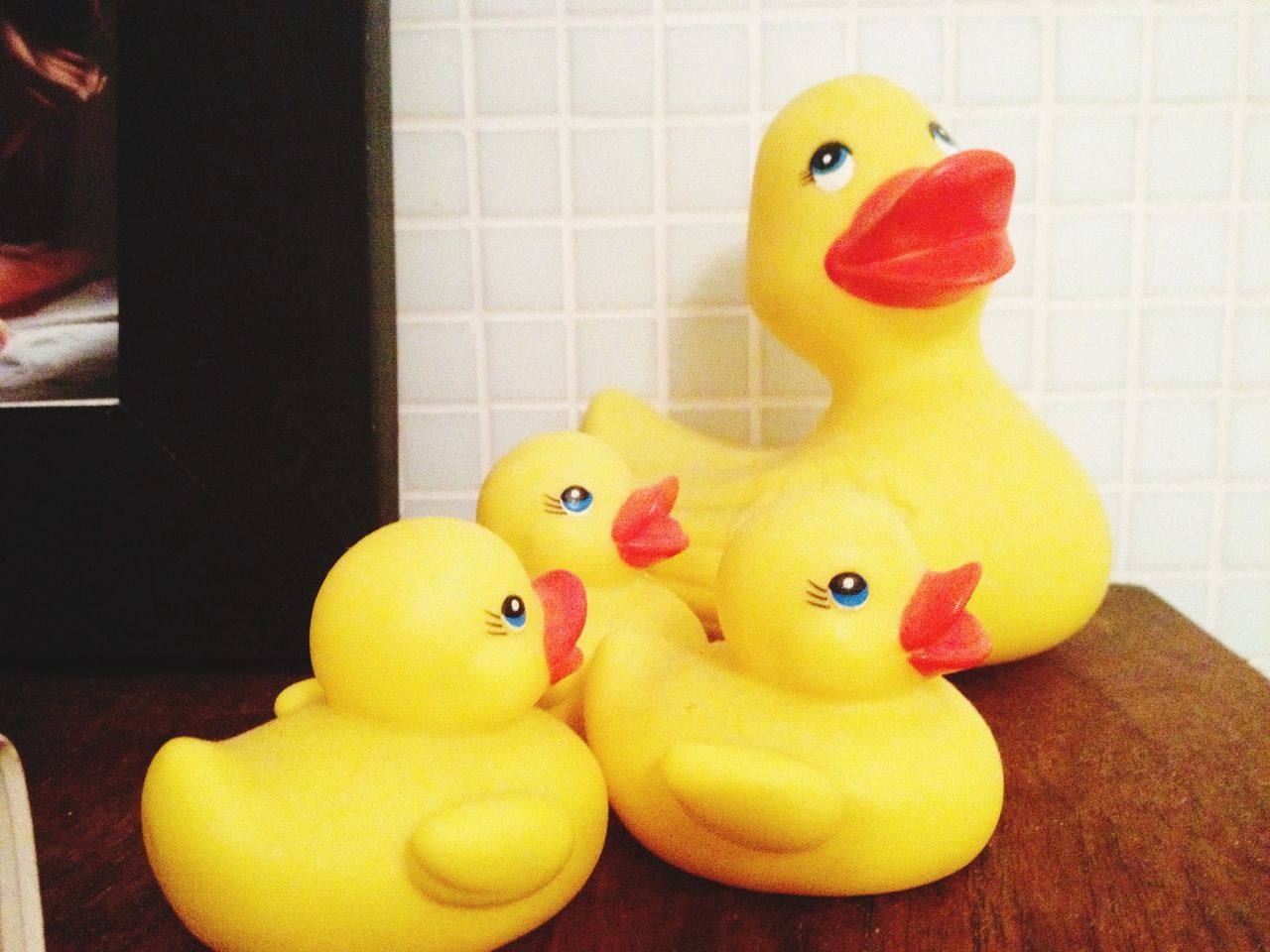 Close-up side view of plastic ducks on table