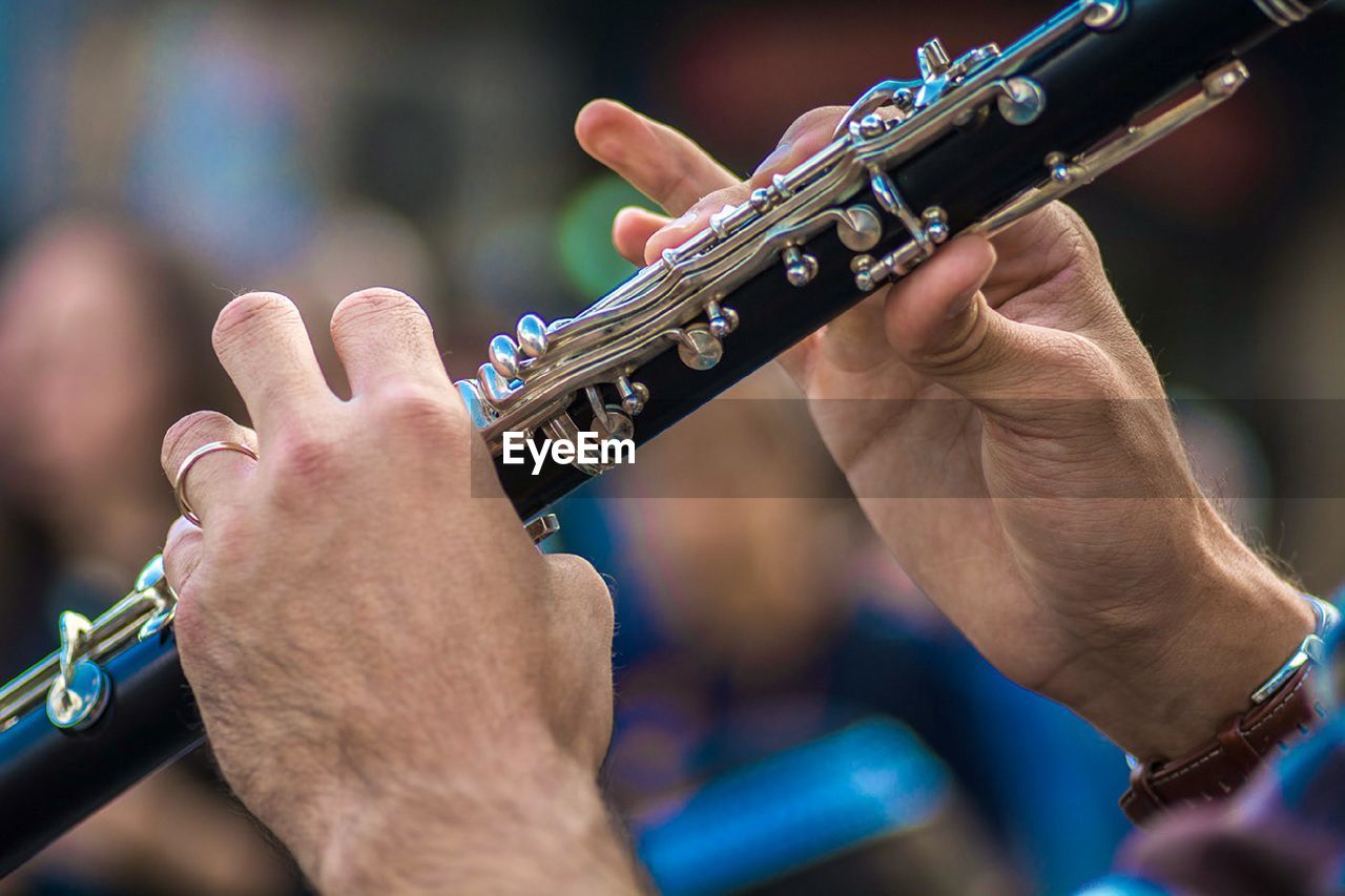 Cropped hand of man holding musical instrument