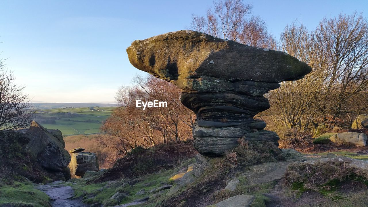 STATUE OF ROCK FORMATIONS IN THE BACKGROUND