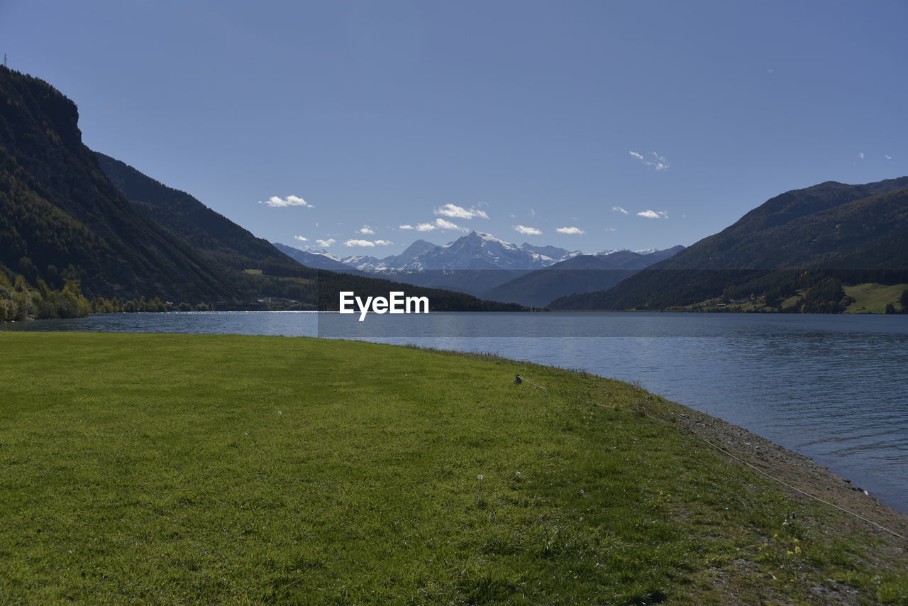 SCENIC VIEW OF LAKE AGAINST MOUNTAINS