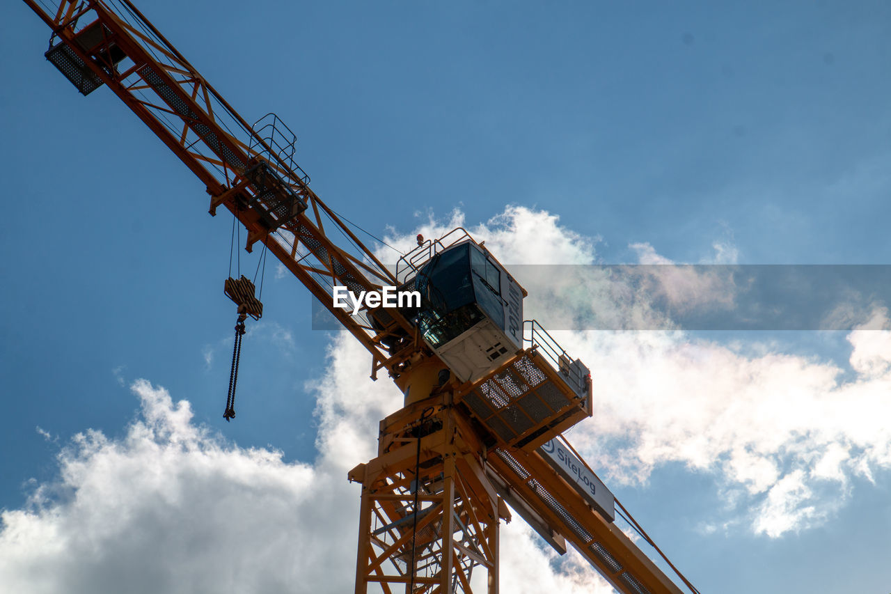 Low angle view of crane against sky