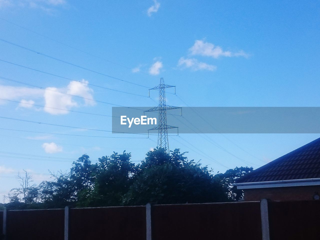 LOW ANGLE VIEW OF POWER LINES AGAINST BLUE SKY