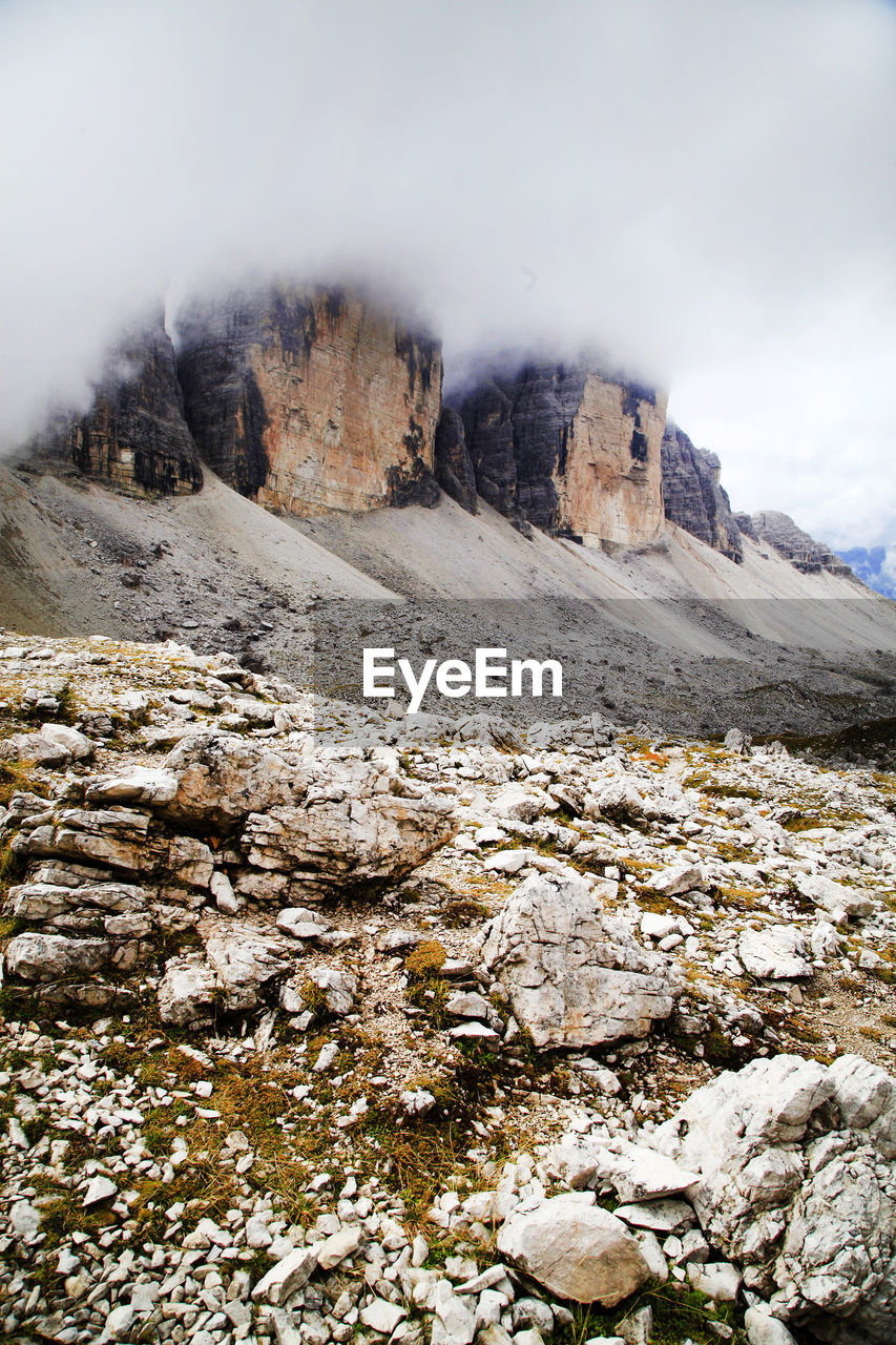 Scenic view of dolomites against cloudy sky