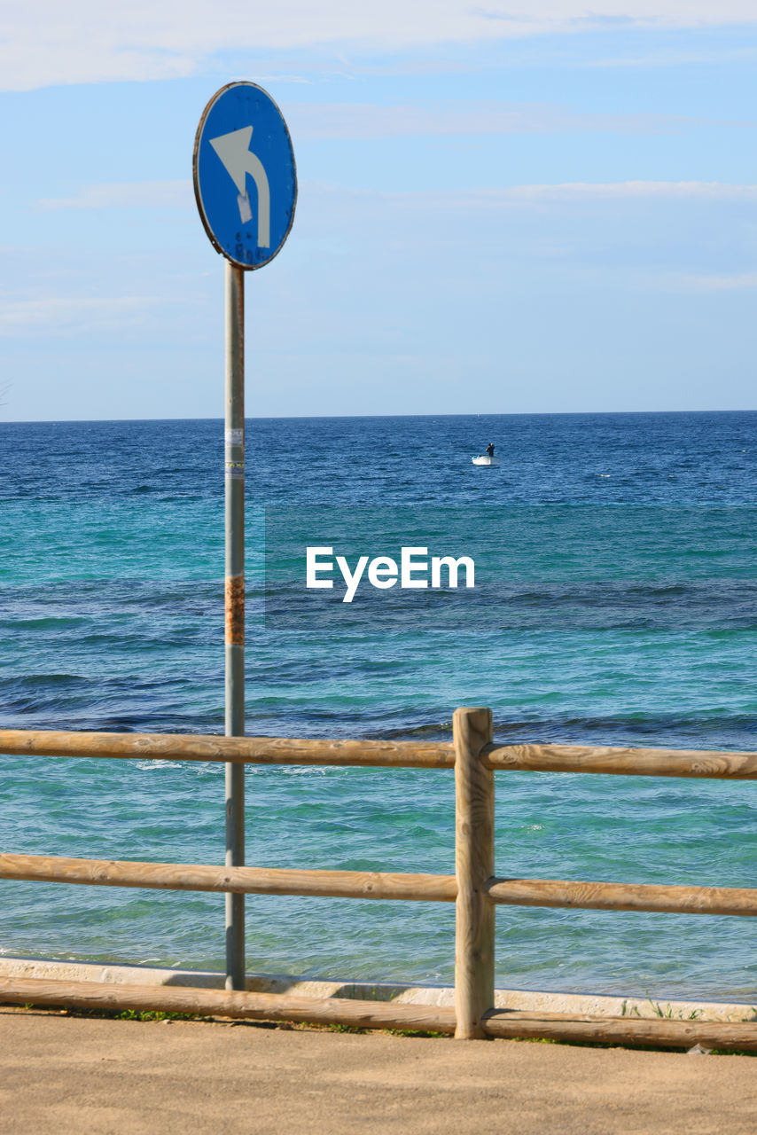 water, blue, sea, ocean, beach, coast, body of water, horizon over water, shore, sky, horizon, vacation, nature, day, sign, no people, beauty in nature, wave, scenics - nature, land, tranquility, tranquil scene, guidance, communication, outdoors, sand, azure, road sign, pole, information sign, wind, bay, cloud, wind wave, non-urban scene, idyllic