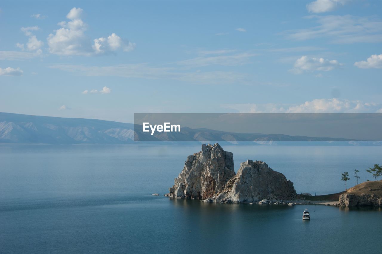 Scenic view of sea and mountains against sky