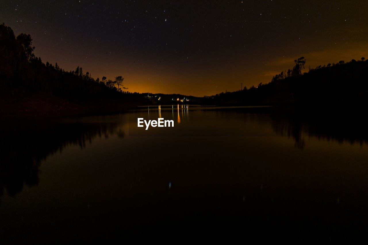 SCENIC VIEW OF LAKE AT SUNSET