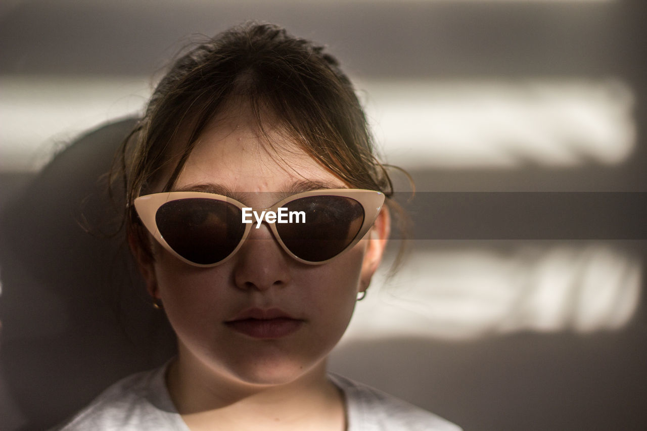 Portrait of young woman wearing sunglasses