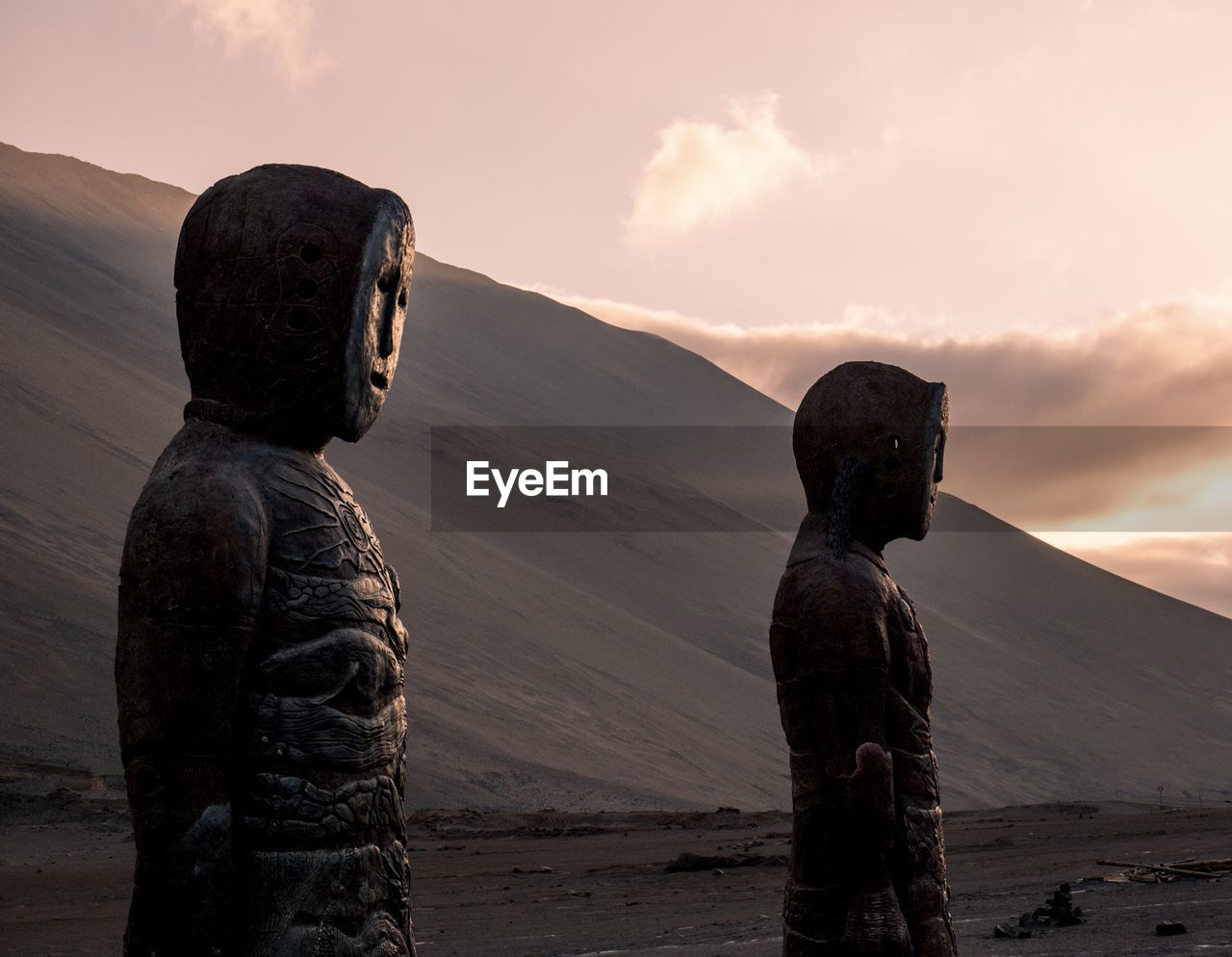 Statue of man standing on land against sky during sunset. chinchorro mummy .