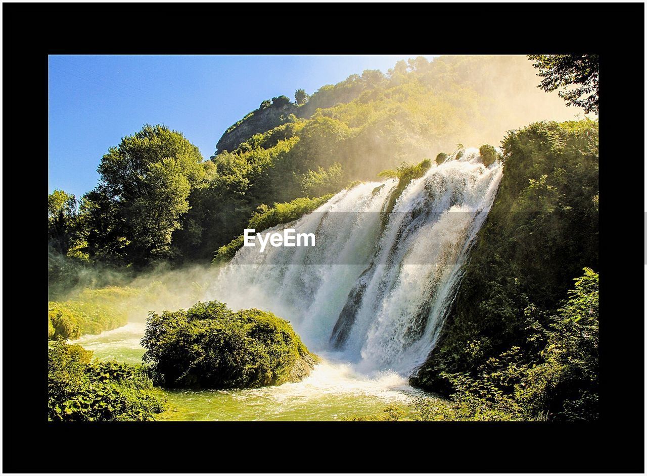 CLOSE-UP OF WATERFALL AGAINST SKY