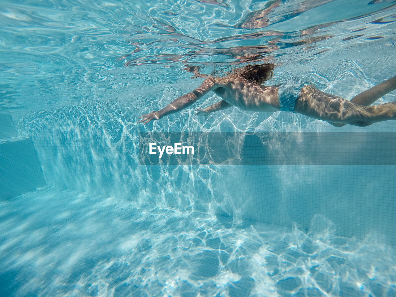 WOMAN SWIMMING IN POOL