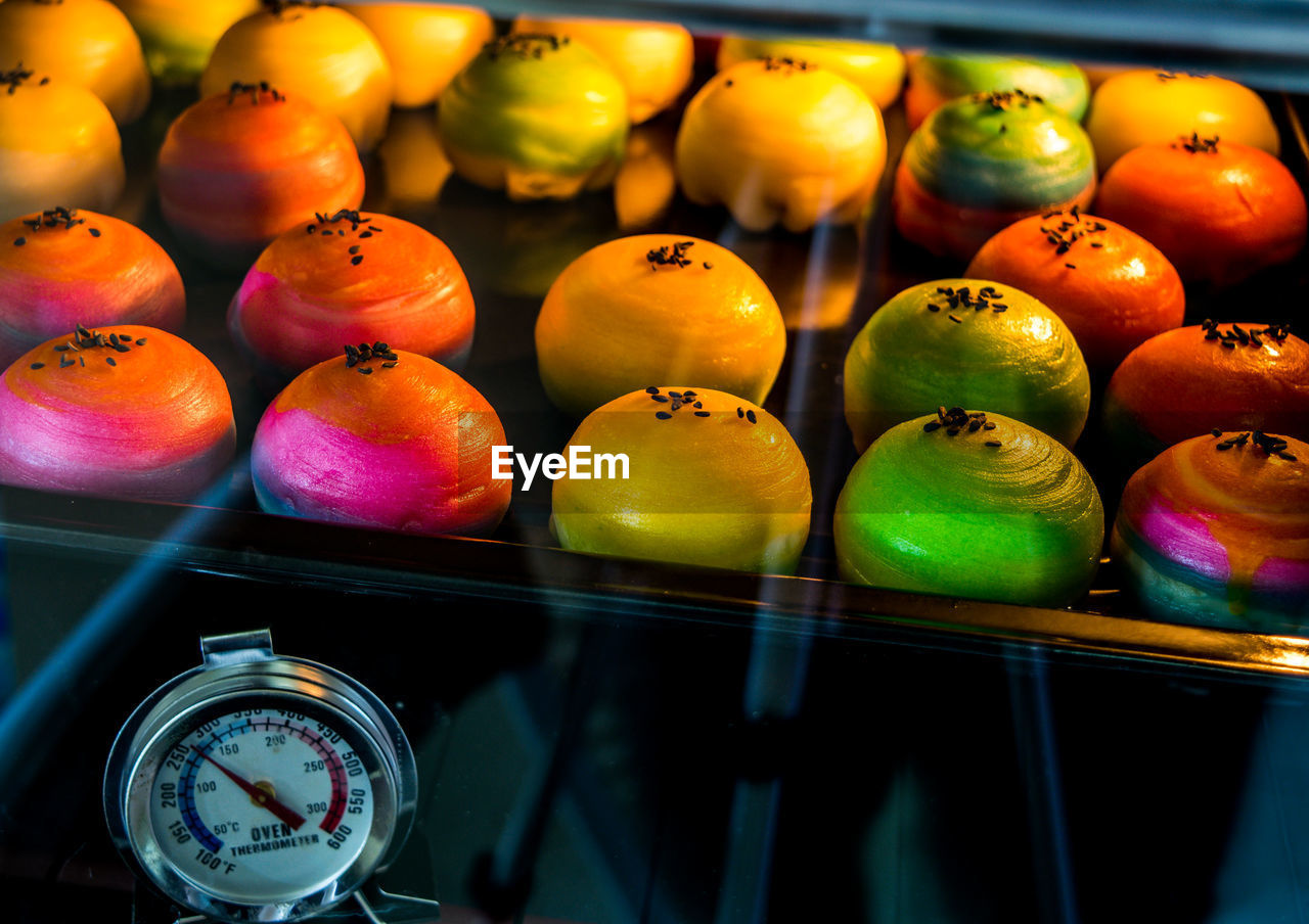 HIGH ANGLE VIEW OF MULTI COLORED FRUITS IN CONTAINER