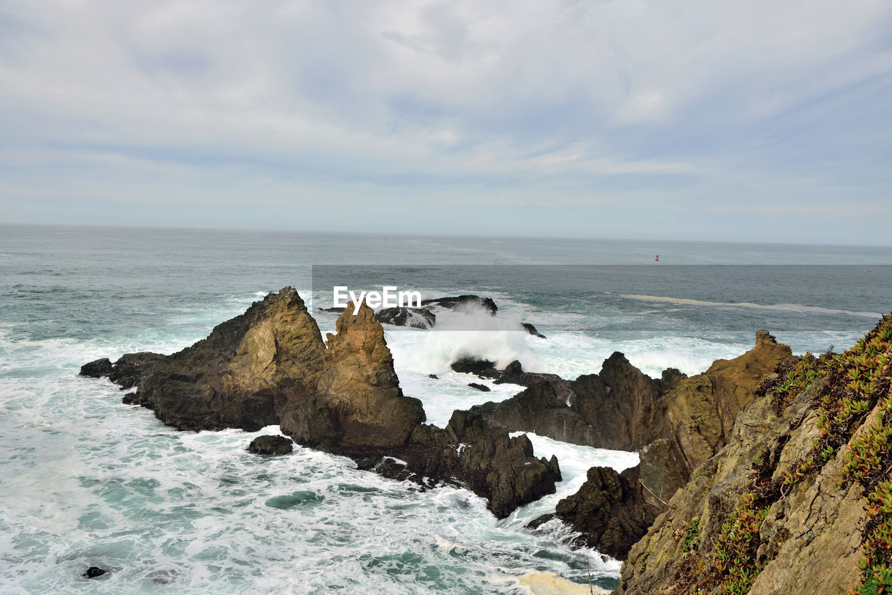 PANORAMIC VIEW OF SEA AND ROCKS AGAINST SKY