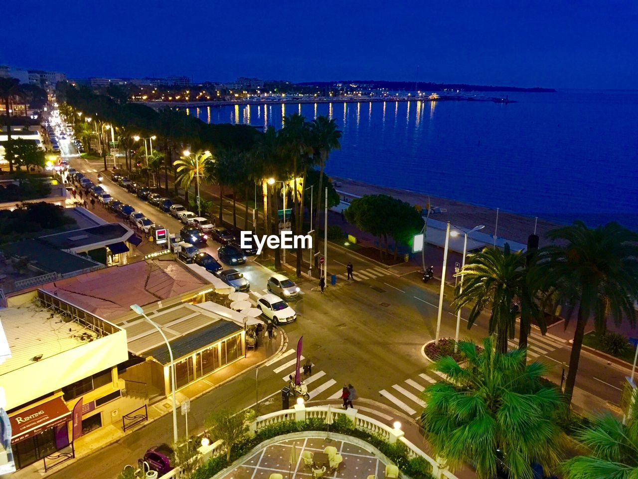 VIEW OF ILLUMINATED CITYSCAPE AT NIGHT