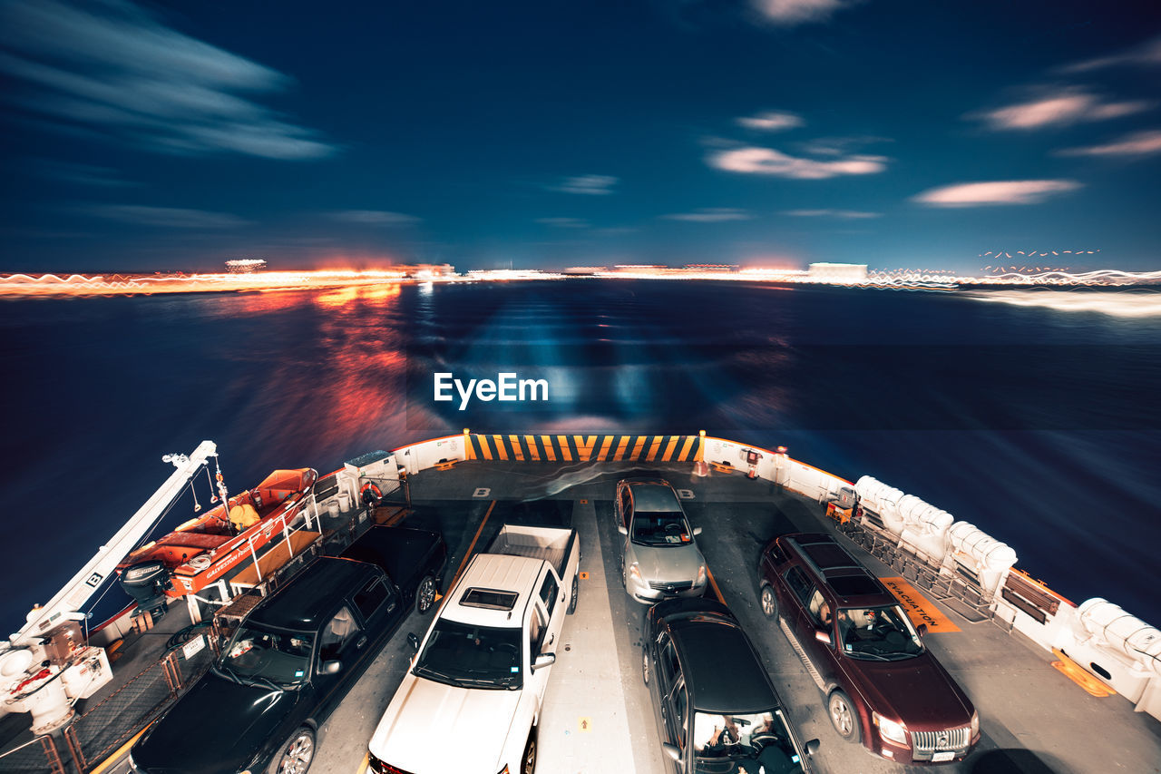 HIGH ANGLE VIEW OF ILLUMINATED SHIP AGAINST SKY