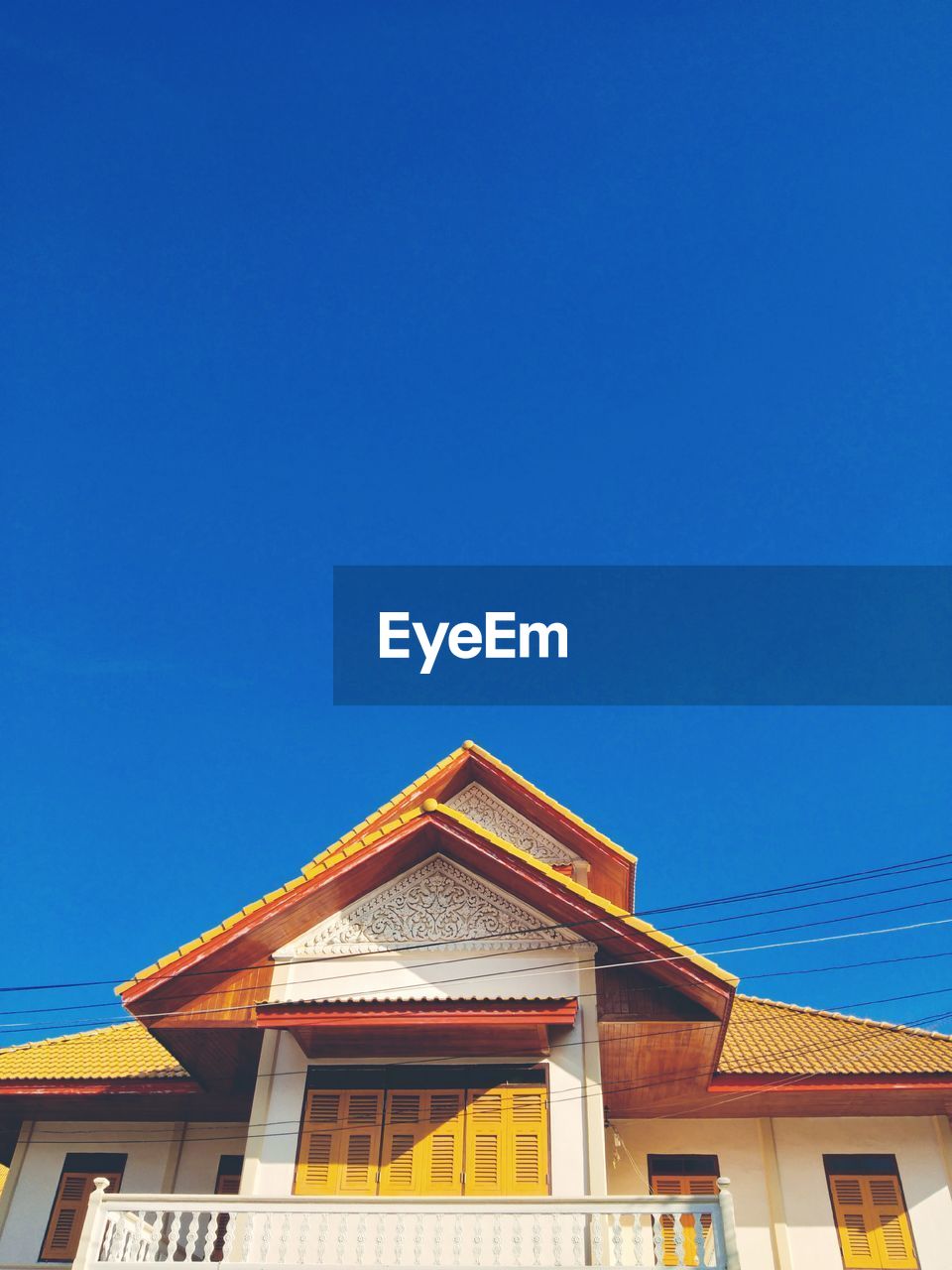 Low angle view of building against clear blue sky