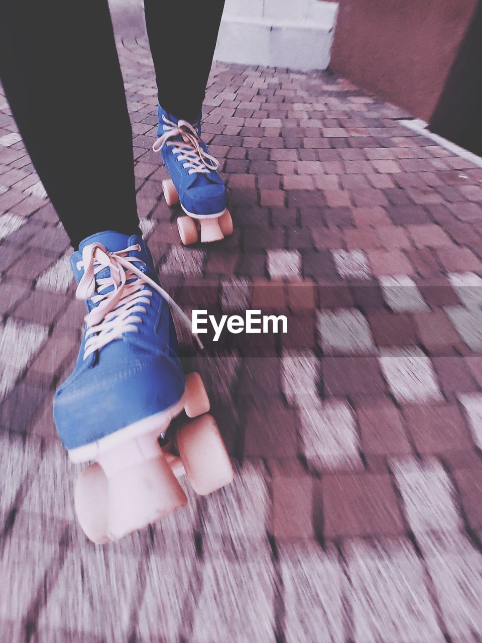 Low section of woman roller skating down the path