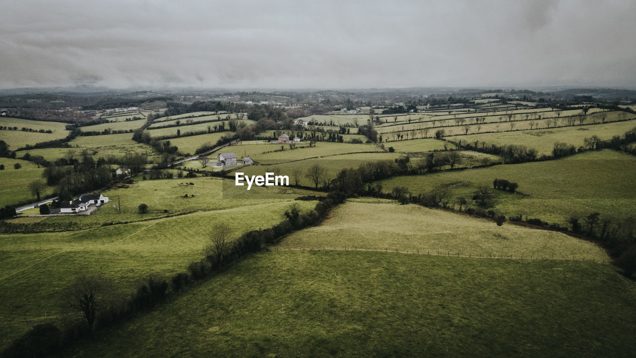 Scenic view of agricultural landscape against sky