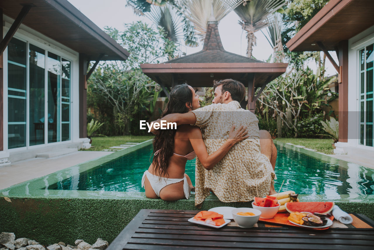 COUPLE HOLDING SWIMMING POOL