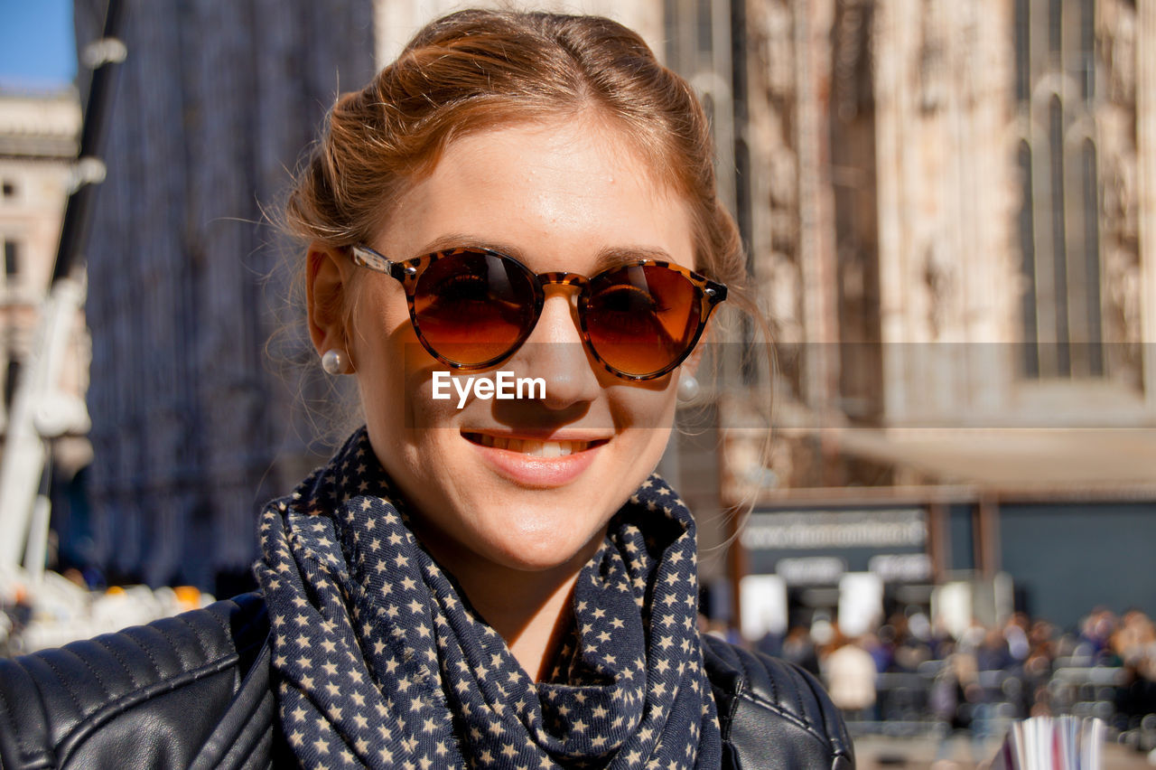 Portrait of smiling young woman wearing sunglasses