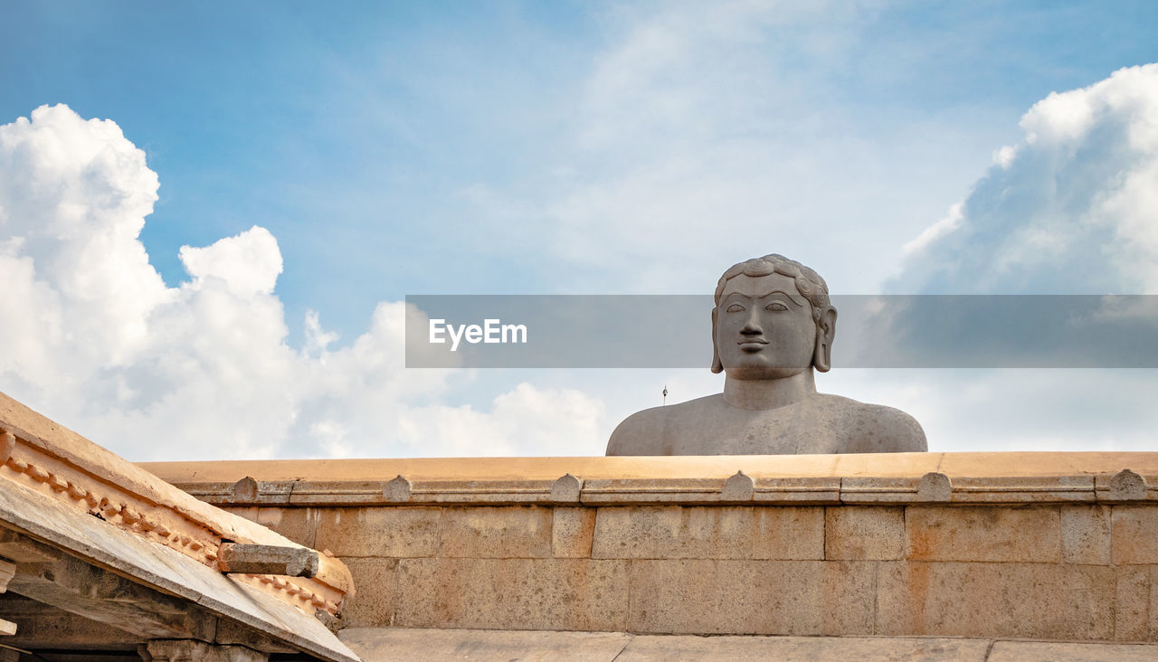 Low angle view of statue against cloudy sky