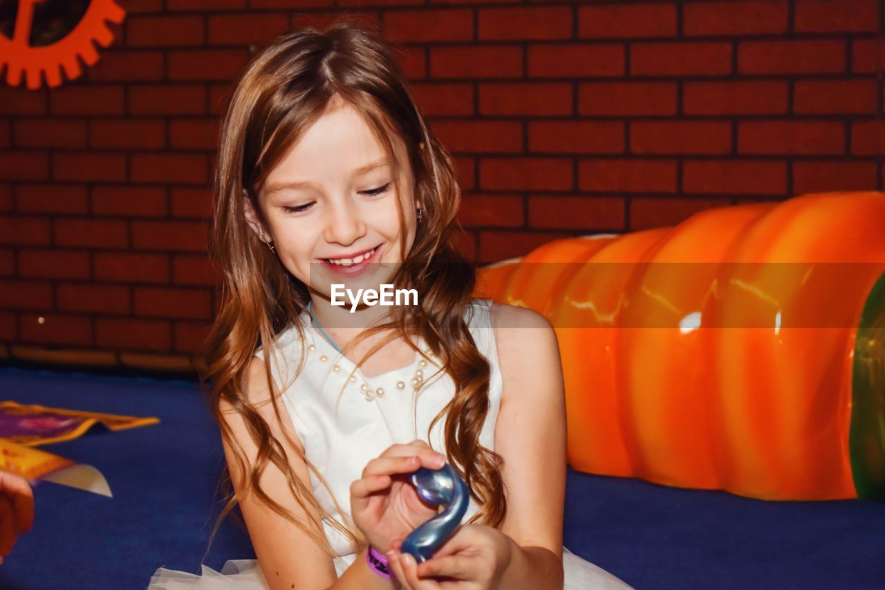 Portrait of smiling girl holding slime 