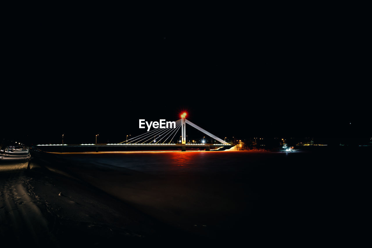 ILLUMINATED BRIDGE AT NIGHT