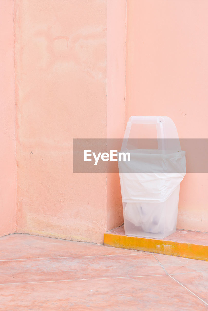 CLOSE-UP OF WHITE DOOR WITH ORANGE WALL IN HOUSE