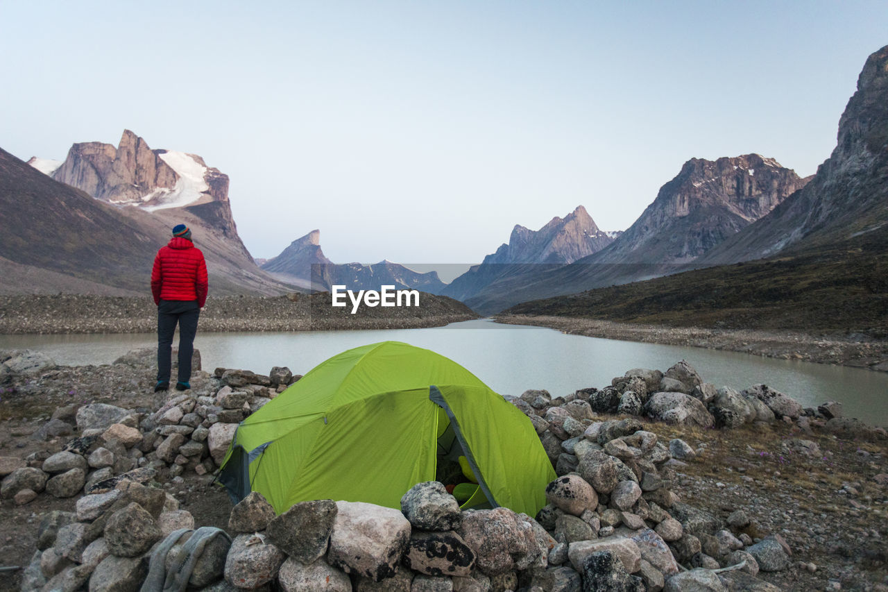 Climber enjoys view of summit lake from his campsite in akshayak pass