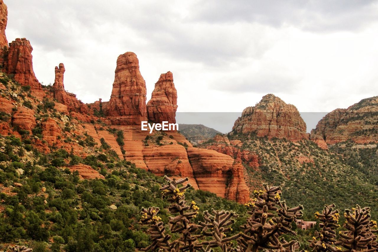 Scenic view of mountains against cloudy sky