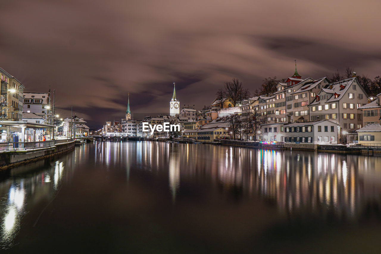 Reflection of illuminated buildings in water at night