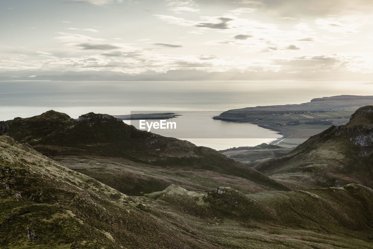 Scenic view of sea and mountains against sky