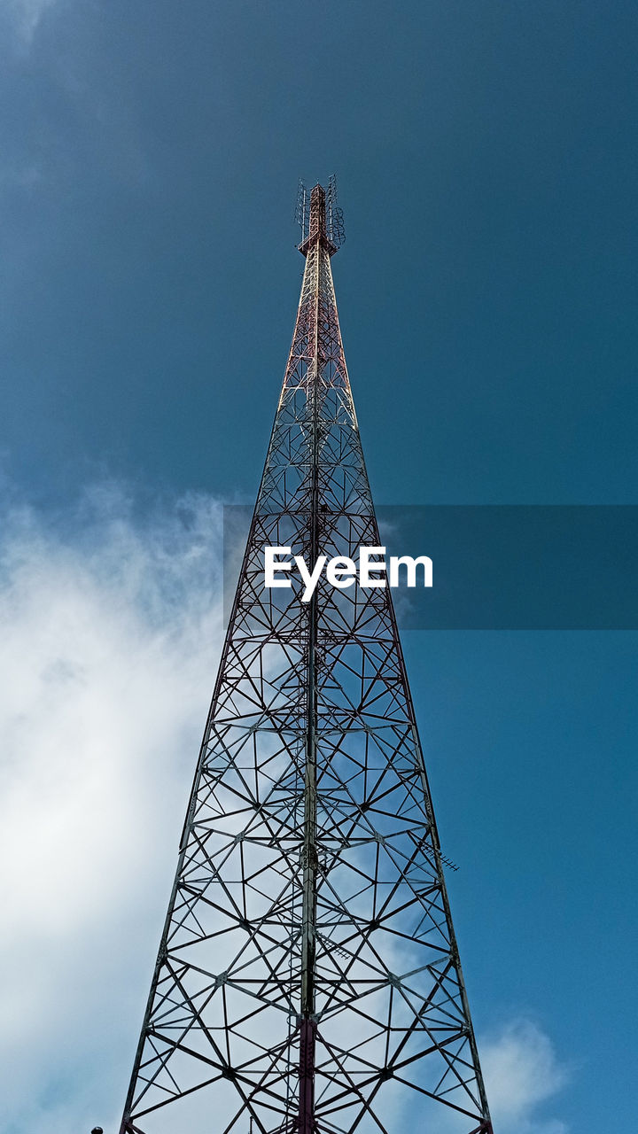 Low angle view of communications tower against sky