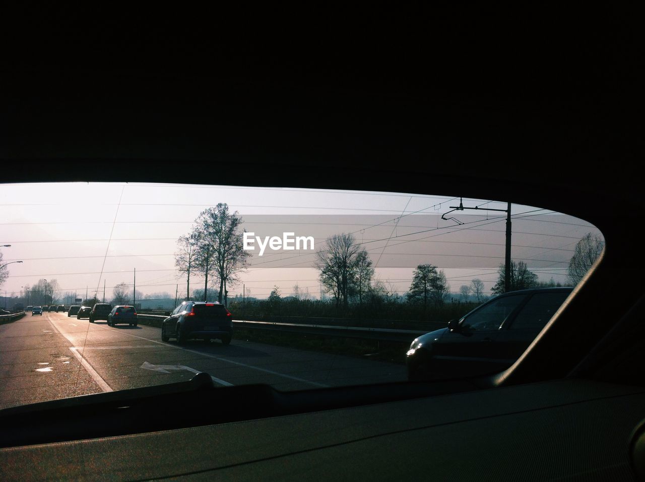 ROAD SEEN THROUGH CAR WINDSHIELD