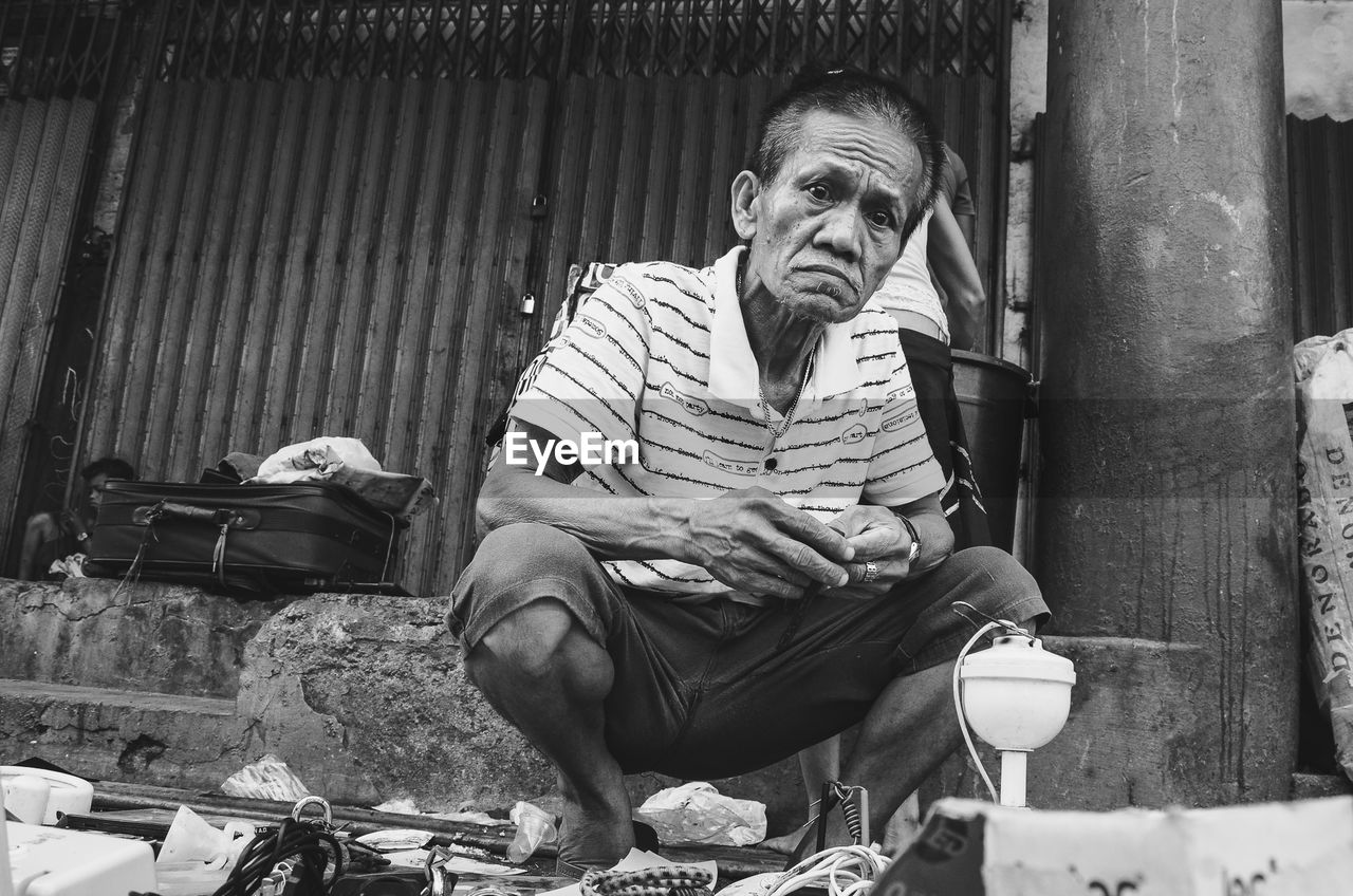 Portrait of mature man crouching