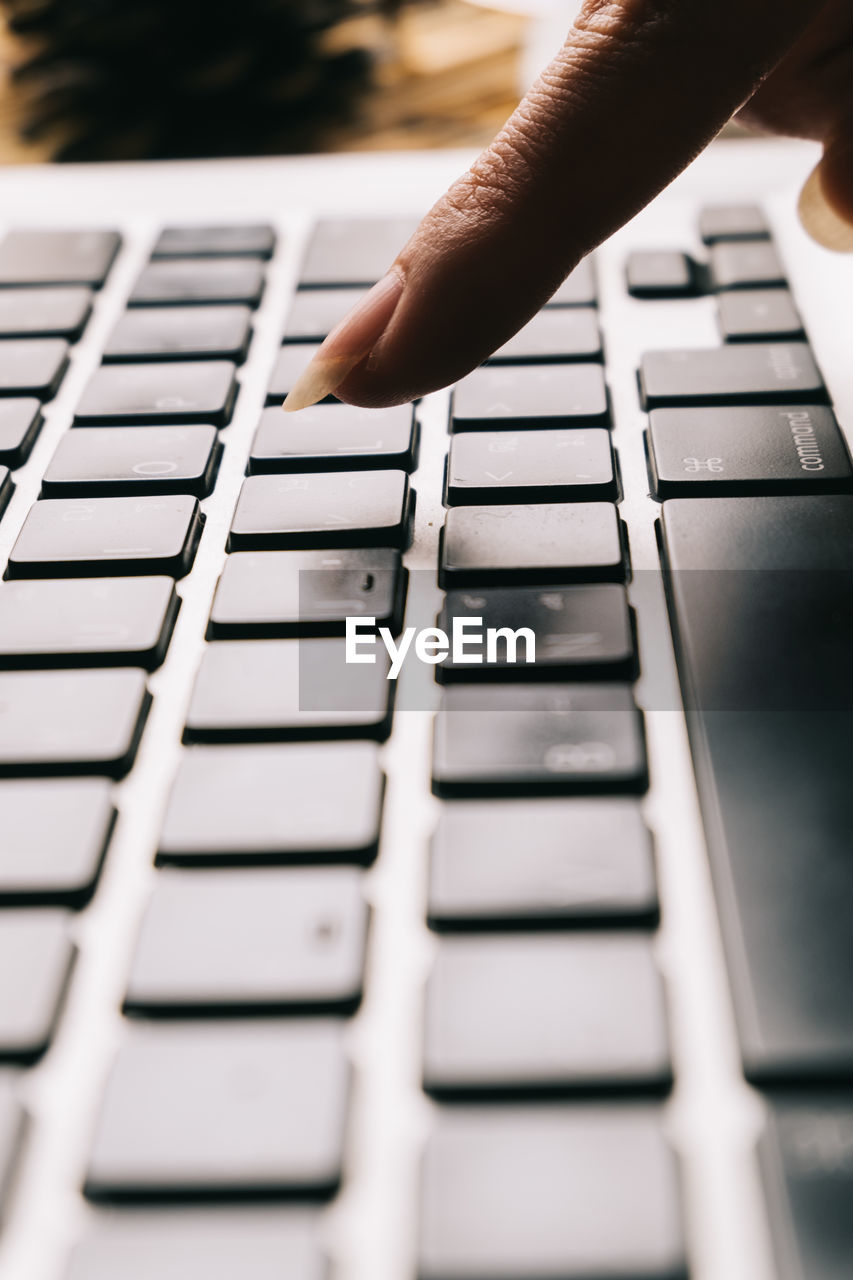 LOW ANGLE VIEW OF LAPTOP KEYBOARD