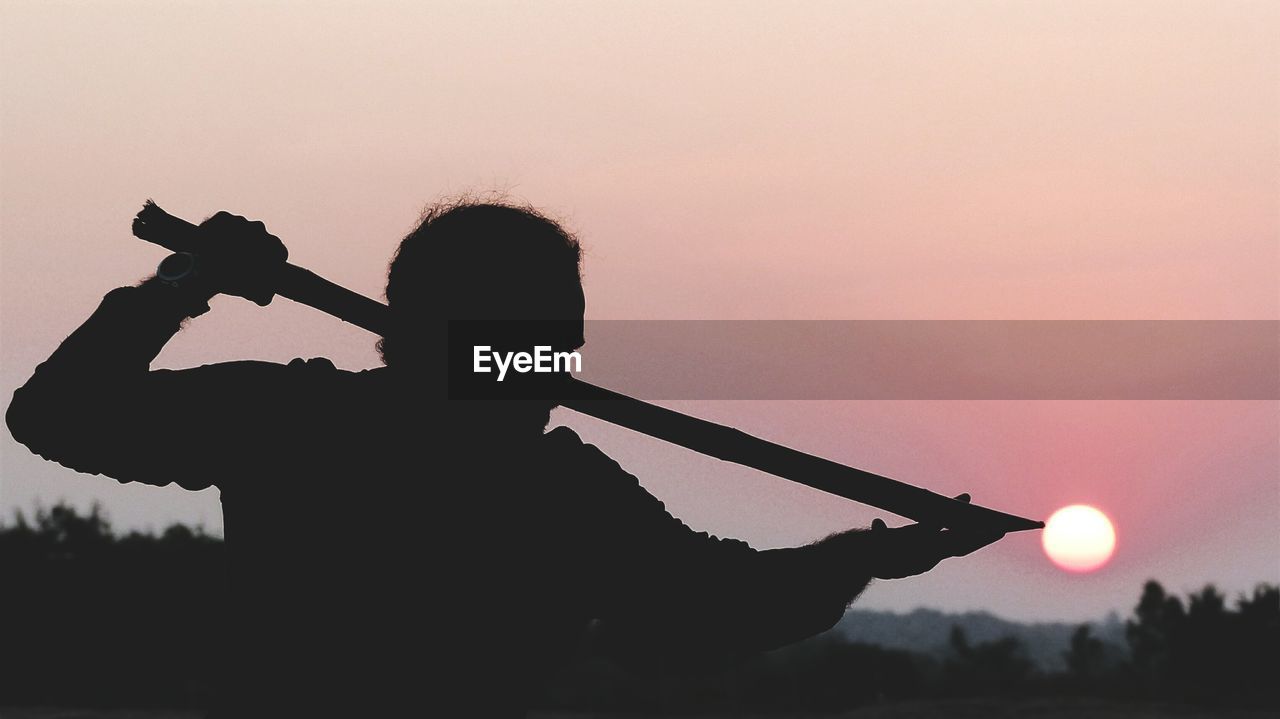 SILHOUETTE MAN STANDING AGAINST SKY