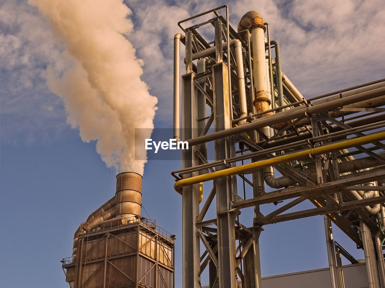 LOW ANGLE VIEW OF FACTORY AGAINST SKY