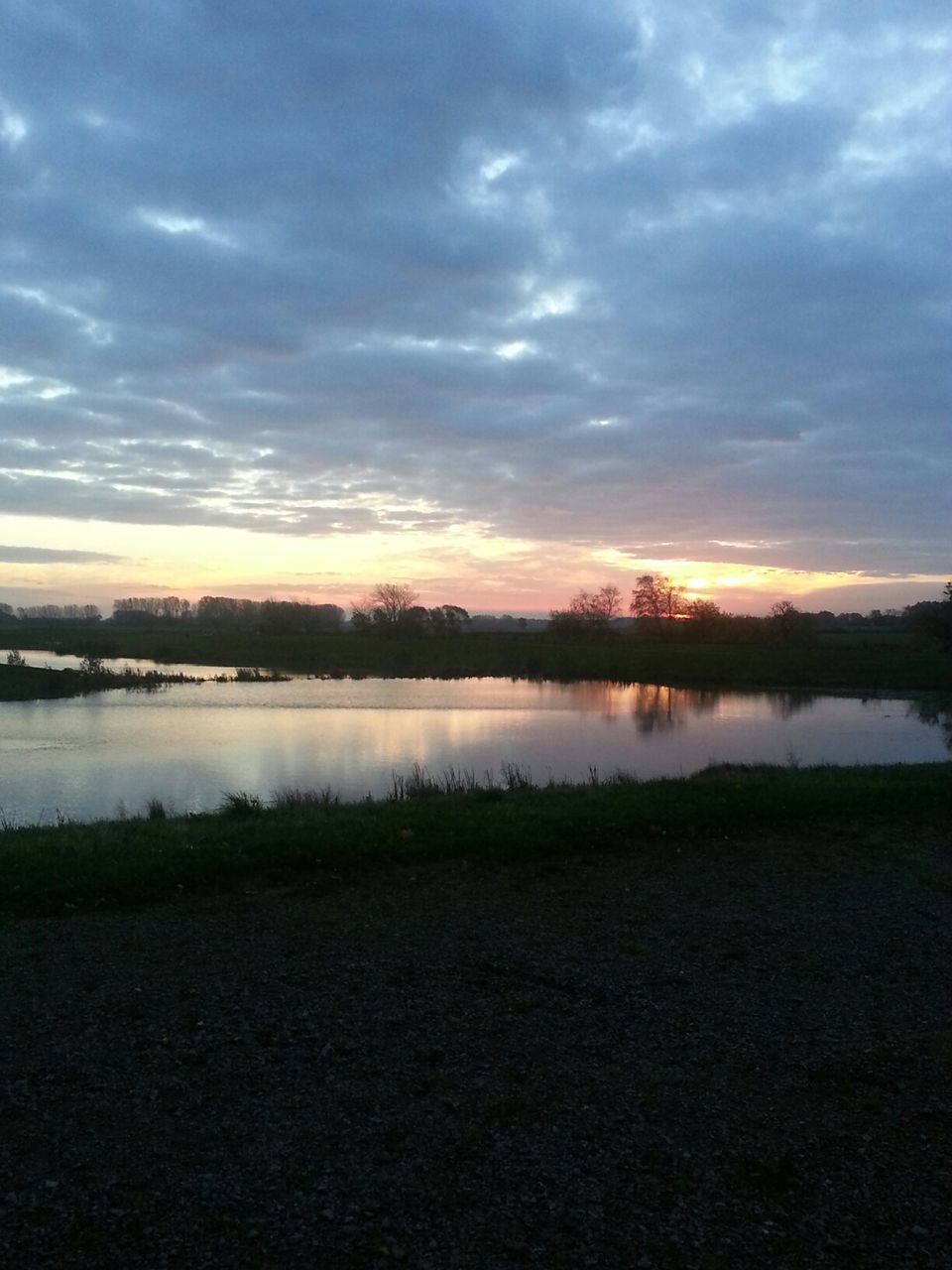 SCENIC VIEW OF LAKE AT SUNSET