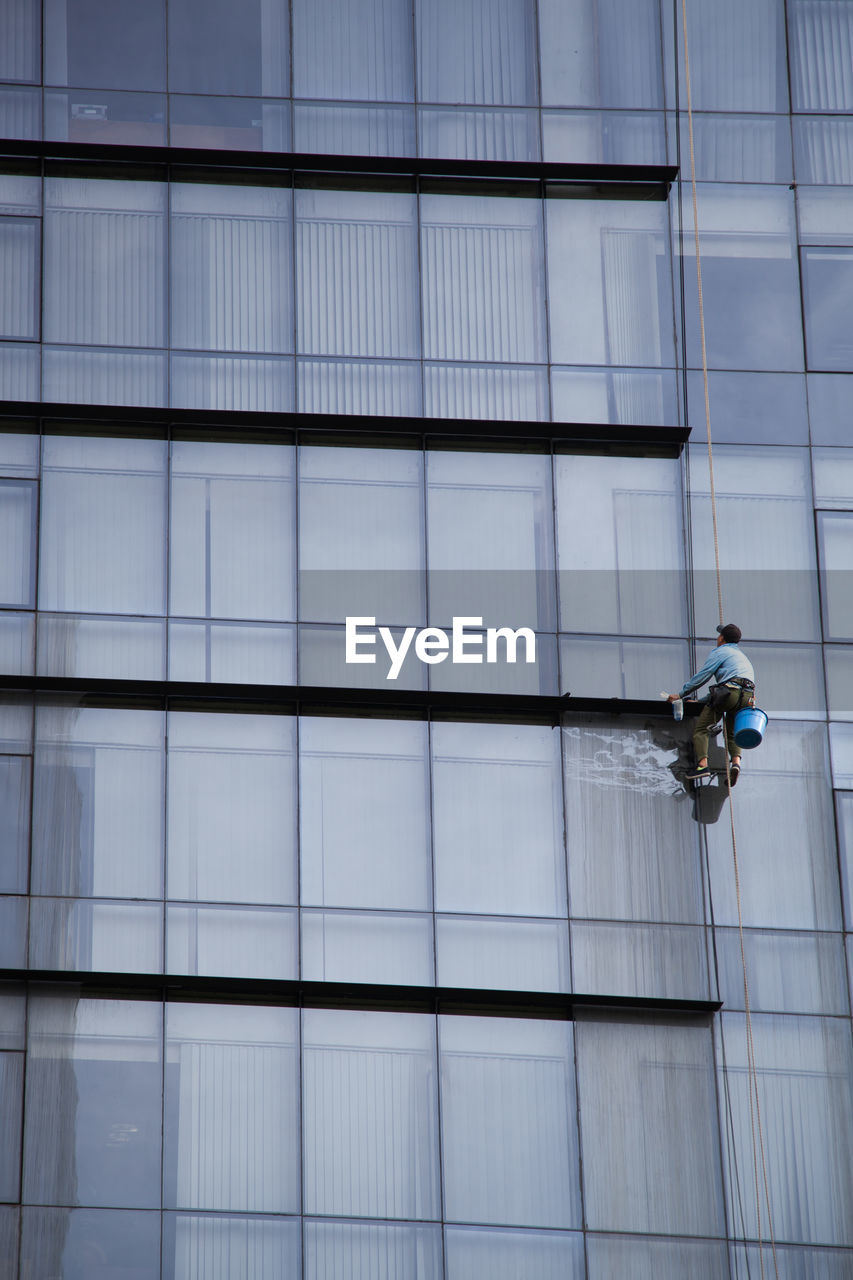 LOW ANGLE VIEW OF OFFICE BUILDING WITH GLASS CEILING