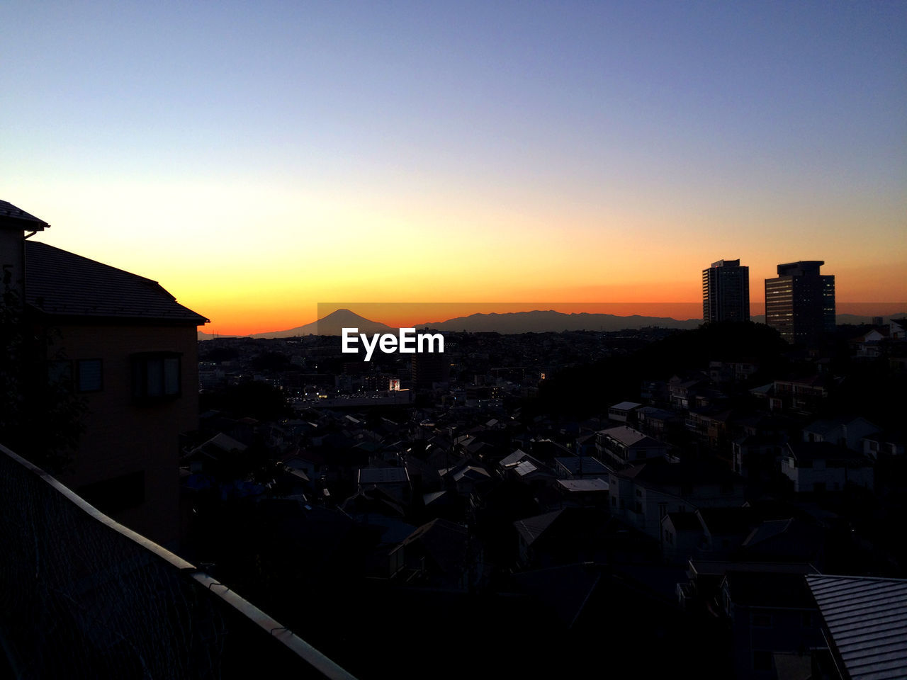 Cityscape against clear sky during sunset