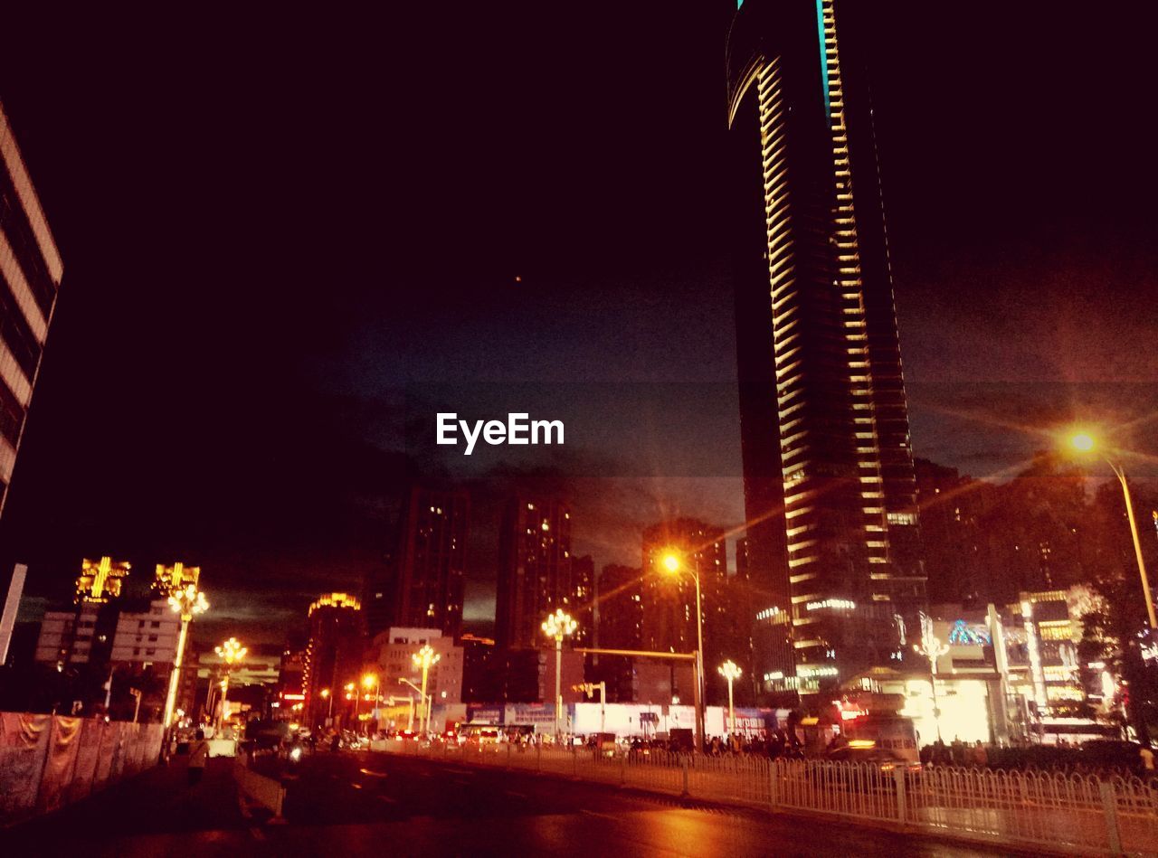 ILLUMINATED BUILDINGS IN CITY AT NIGHT