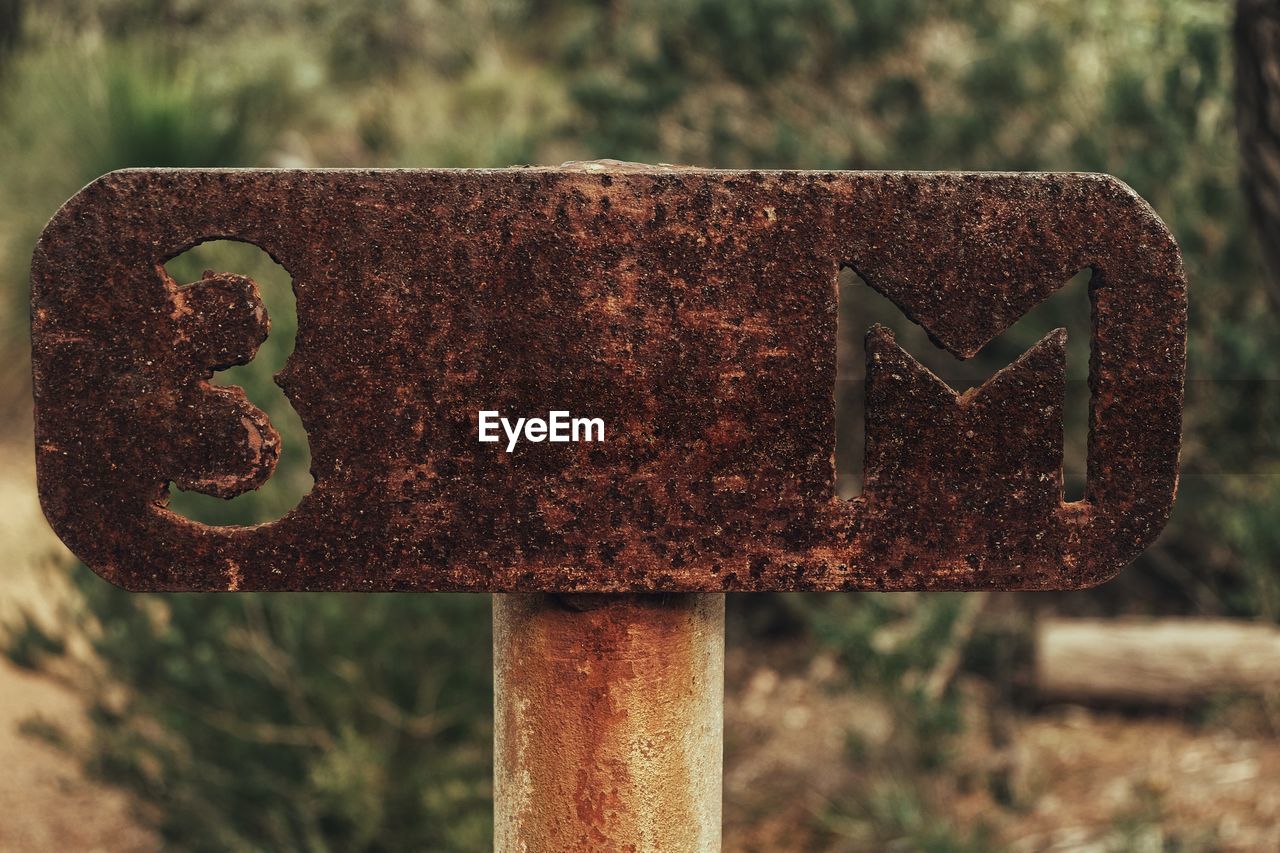 Close-up of rusty road sign