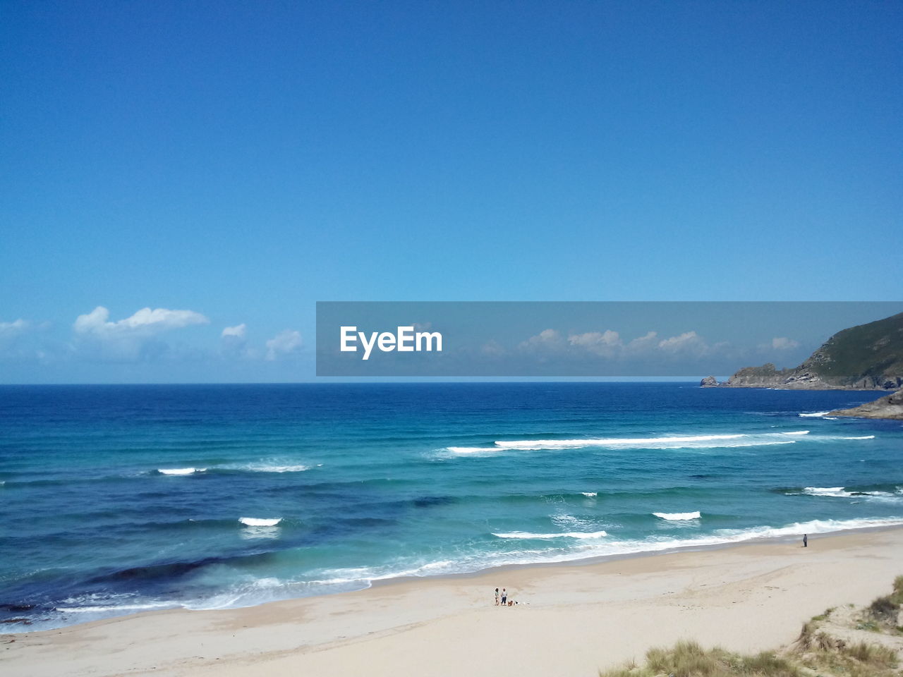 Scenic view of sea against blue sky