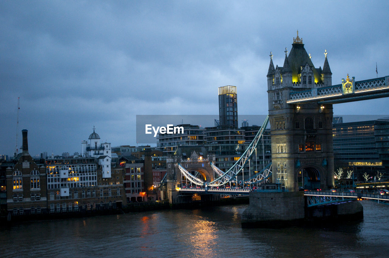 Bridge over river with buildings in background