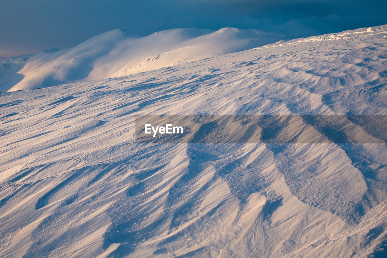 Aerial view of snowcapped mountains against sky