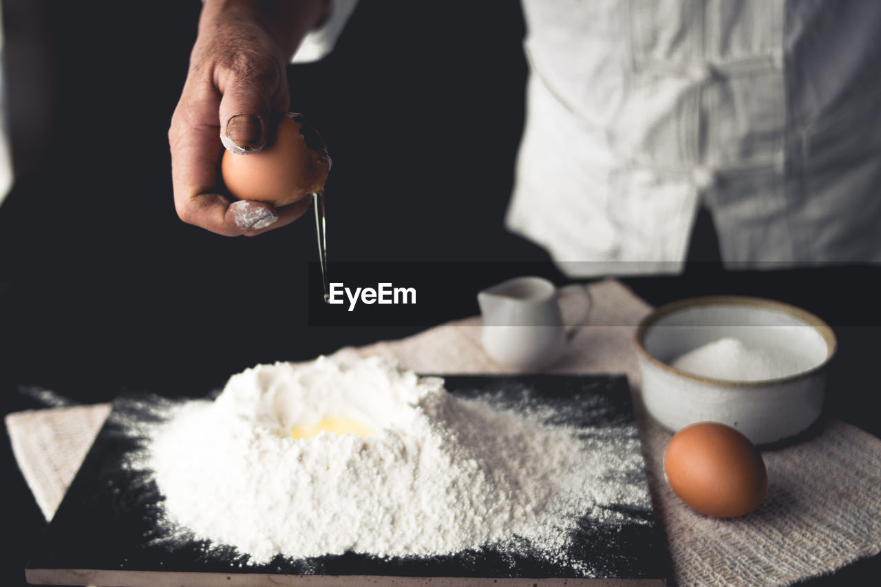 Close-up of person preparing food on table