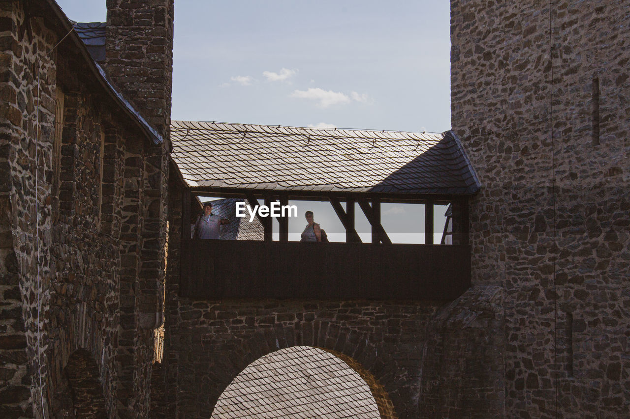 PEOPLE ON WALL OF BUILDING