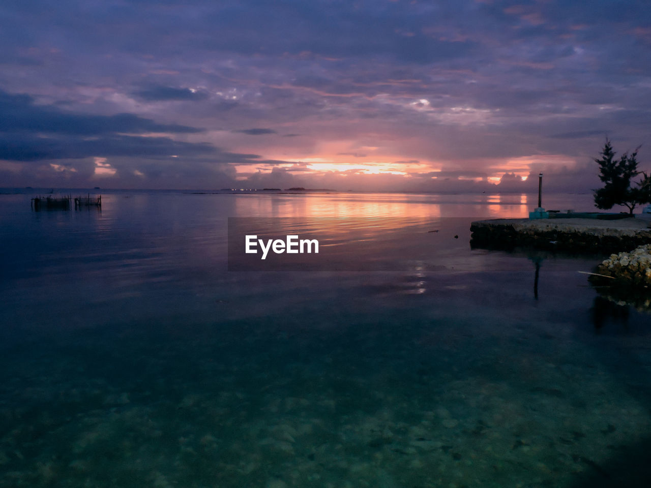 SCENIC VIEW OF SWIMMING POOL AGAINST SKY DURING SUNSET